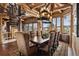 Elegant dining room with a spiral staircase, mountain views, and a large table for entertaining at 300 Little Sallie Barber Trl, Breckenridge, CO 80424
