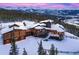 Luxury mountain home with multiple garage spaces, snowy roof, and spectacular mountain views at 300 Little Sallie Barber Trl, Breckenridge, CO 80424