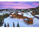 Stunning mountain home with a snow-covered roof and gorgeous views from the many windows and balconies at 300 Little Sallie Barber Trl, Breckenridge, CO 80424