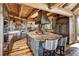 Spacious kitchen with a large island, custom cabinets, wooden beams, and modern appliances at 300 Little Sallie Barber Trl, Breckenridge, CO 80424