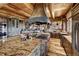 Gourmet kitchen with expansive island, granite countertops, wood cabinetry, and high-end appliances at 300 Little Sallie Barber Trl, Breckenridge, CO 80424