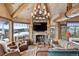 Cozy living room with stone fireplace and mountain views at 300 Little Sallie Barber Trl, Breckenridge, CO 80424