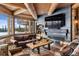 Inviting living room with a fireplace, exposed beams, and comfortable leather seating at 300 Little Sallie Barber Trl, Breckenridge, CO 80424