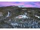 Luxury home surrounded by snow-covered trees and mountains at 300 Little Sallie Barber Trl, Breckenridge, CO 80424