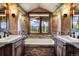 Bathroom with double sinks and mountain views at 300 Little Sallie Barber Trl, Breckenridge, CO 80424