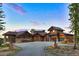 Impressive log home featuring a grand entrance, multi-car garage, and meticulously landscaped grounds at 300 Little Sallie Barber Trl, Breckenridge, CO 80424