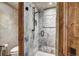 Walk-in shower with glass enclosure and stone tile at 300 Little Sallie Barber Trl, Breckenridge, CO 80424