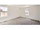 Empty bedroom featuring plush carpeting and a sunlit window at 21964 E 39Th Ave, Aurora, CO 80019