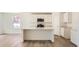 Bright kitchen with an island, stainless steel appliances, stone countertops, and a door leading to the backyard at 21964 E 39Th Ave, Aurora, CO 80019