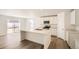 Modern kitchen features an island, stainless steel appliances, white cabinetry, and an open concept to the backyard at 21964 E 39Th Ave, Aurora, CO 80019