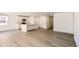 Bright and airy living room featuring hardwood floors with an open floor plan flowing into the kitchen at 21964 E 39Th Ave, Aurora, CO 80019