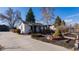Charming single-story home with a well-maintained front yard and a driveway leading to a detached garage at 437 Raleigh St, Denver, CO 80204