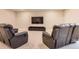 Finished basement featuring comfortable leather seating, entertainment center, and ample space for relaxation at 9162 Star Streak Cir, Littleton, CO 80125