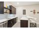 Basement bar with sink, dishwasher, cabinets, and mini fridge, and white bar seating at 9162 Star Streak Cir, Littleton, CO 80125
