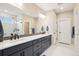 A spacious bathroom with dual sinks, a tiled shower, and plenty of natural light at 9162 Star Streak Cir, Littleton, CO 80125