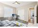 This bedroom has a ceiling fan, natural light, and an exterior view at 9162 Star Streak Cir, Littleton, CO 80125