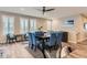 Bright dining room featuring modern table and chairs set, stylish ceiling fan, and natural light from shuttered windows at 9162 Star Streak Cir, Littleton, CO 80125