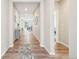 Bright hallway with wood floors that leads to an open living space. Recessed lights and neutral paint at 9162 Star Streak Cir, Littleton, CO 80125