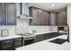 Close-up of a well-appointed kitchen featuring stainless steel appliances, custom cabinets and quartz countertops at 9162 Star Streak Cir, Littleton, CO 80125