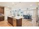 Stylish kitchen island with dark wood cabinets, modern stainless appliances, and pendant lighting at 9162 Star Streak Cir, Littleton, CO 80125