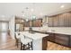 Bright, modern kitchen with stainless appliances, white countertops, wood floors and unique lighting at 9162 Star Streak Cir, Littleton, CO 80125