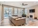 Living room featuring an electric reclining sofa, fireplace and sliding glass doors to the patio at 9162 Star Streak Cir, Littleton, CO 80125