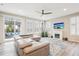 Spacious living room with fireplace, lots of natural light and a leather sofa. Access to outdoor space at 9162 Star Streak Cir, Littleton, CO 80125