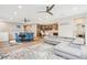 Open concept living space with an open dining area, kitchen, and comfortable gray couches at 9162 Star Streak Cir, Littleton, CO 80125