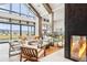 A spacious community lobby with a fireplace, ample seating and exterior views at 9162 Star Streak Cir, Littleton, CO 80125