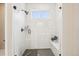 A luxurious shower with marble tile, black hardware, and a built-in bench at 9162 Star Streak Cir, Littleton, CO 80125