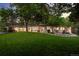 Expansive backyard with lush green grass, mature trees, and an inviting outdoor patio area at 3901 S Dexter St, Cherry Hills Village, CO 80113