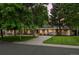 Attractive home with a well-kept front lawn, mature trees, and a long driveway at 3901 S Dexter St, Cherry Hills Village, CO 80113