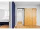 Bright hallway with hardwood floors leads to a bedroom and a full bathroom with modern fixtures at 3901 S Dexter St, Cherry Hills Village, CO 80113
