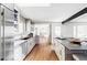 Modern kitchen with stone countertops, sleek appliances, and an open layout to adjacent living spaces at 3901 S Dexter St, Cherry Hills Village, CO 80113
