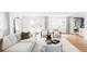 Bright living room with hardwood floors, stylish furniture, and large windows offering plenty of natural light at 3901 S Dexter St, Cherry Hills Village, CO 80113