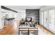 Bright living room with a modern fireplace and exposed beam, leading to an open-plan kitchen at 3901 S Dexter St, Cherry Hills Village, CO 80113