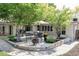 Back patio with shade trees, stone pavers, dining set, and fire pit, perfect for relaxing at 3901 S Dexter St, Cherry Hills Village, CO 80113