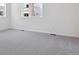 This bedroom features neutral carpet, base trim, and natural light at 8317 Snake River St, Littleton, CO 80125