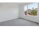 Bright bedroom featuring neutral carpet, white walls and a large window at 8317 Snake River St, Littleton, CO 80125