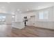 Well-lit kitchen featuring an island with sink, stainless appliances, and hardwood floors at 8317 Snake River St, Littleton, CO 80125