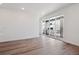 Living room with glass doors to porch, hardwood flooring, and white walls at 8317 Snake River St, Littleton, CO 80125