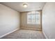 Simple bedroom with a large window and carpeted floors at 15518 W Auburn Ave, Lakewood, CO 80228