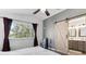 Bedroom features a sliding barn door to the attached bathroom at 13199 Ash St, Thornton, CO 80241
