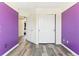 Bedroom with purple accent wall, white trim, and double closet at 13199 Ash St, Thornton, CO 80241