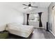 Bright bedroom with vaulted ceiling, a ceiling fan, and dark wood-look floors at 13199 Ash St, Thornton, CO 80241