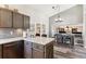 Open-concept kitchen and dining area featuring modern appliances, sleek countertops, and seamless access to adjacent living space at 13199 Ash St, Thornton, CO 80241