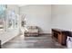 Bright living room features hardwood floors, ample natural light from large windows, and contemporary décor at 13199 Ash St, Thornton, CO 80241