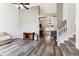 Spacious living room with high ceilings, hardwood floors, neutral paint, and open access to kitchen and staircase at 13199 Ash St, Thornton, CO 80241