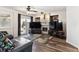 Cozy living room with fireplace, wood floors, and access to the outdoor space at 13199 Ash St, Thornton, CO 80241