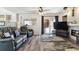 Comfortable living room with fireplace, wood floors, and access to the outdoor space at 13199 Ash St, Thornton, CO 80241